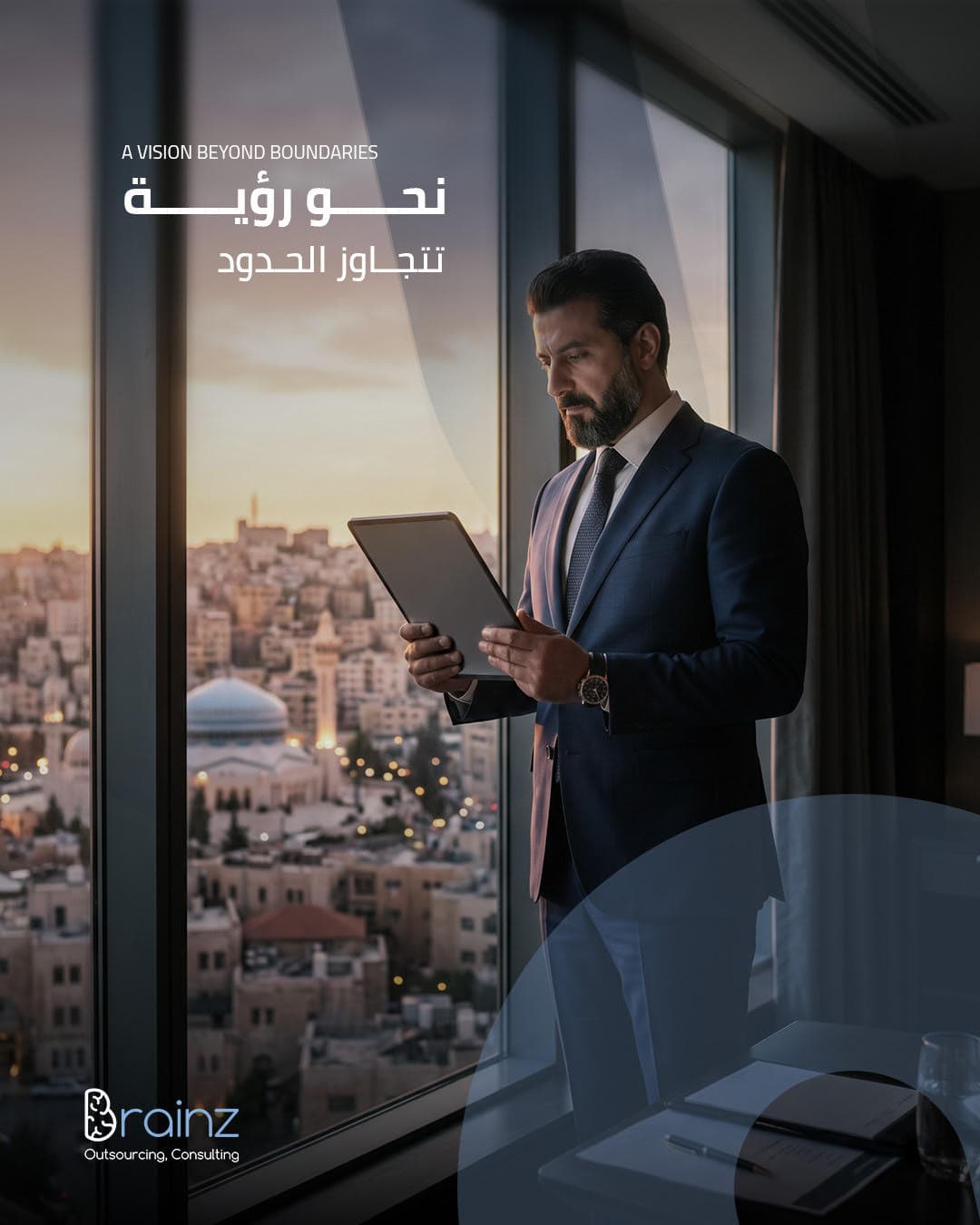 A Brainz executive reviewing a tablet by a window overlooking Amman at sunset.